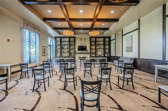 dining room featuring coffered ceiling, a wainscoted wall, a fireplace, beam ceiling, and recessed lighting