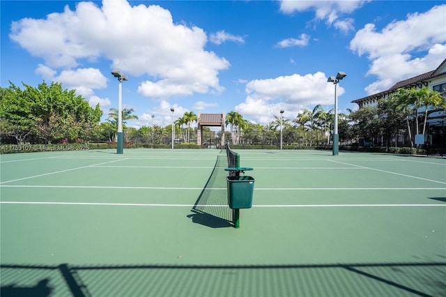 view of tennis court featuring fence