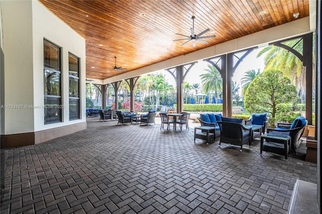 view of patio with outdoor dining area, an outdoor living space, and a ceiling fan