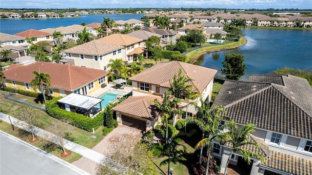 bird's eye view featuring a water view and a residential view