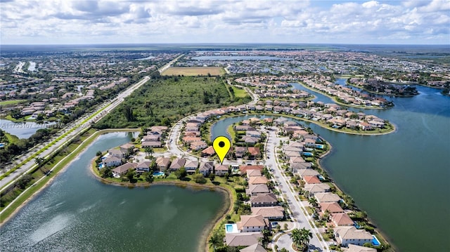 bird's eye view featuring a water view and a residential view