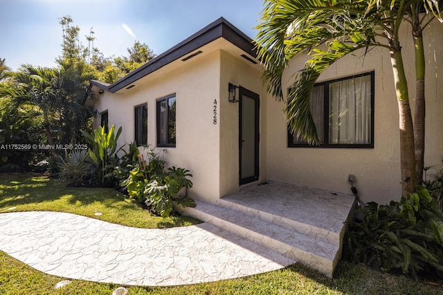 exterior space featuring stucco siding and a patio