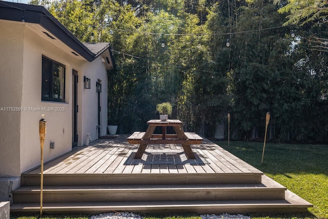 deck featuring a yard and outdoor dining area