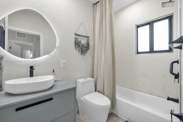 bathroom with shower / bath combo, visible vents, vanity, and toilet