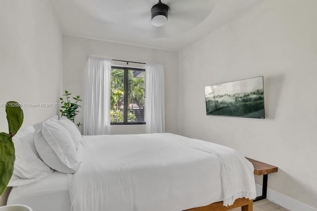 bedroom featuring a ceiling fan and baseboards