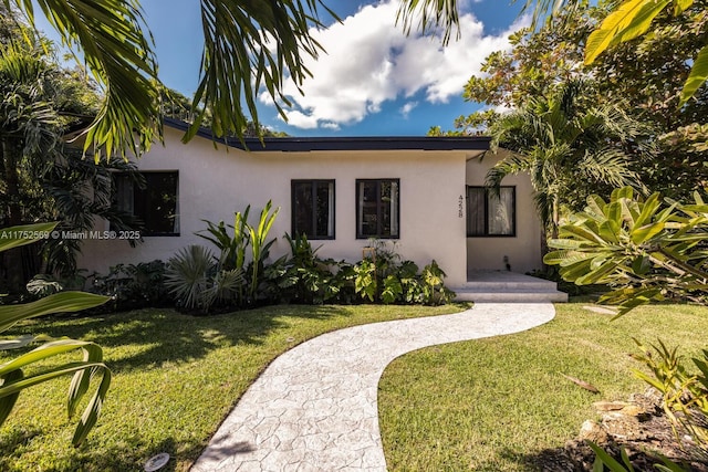 view of front of property featuring a front yard and stucco siding