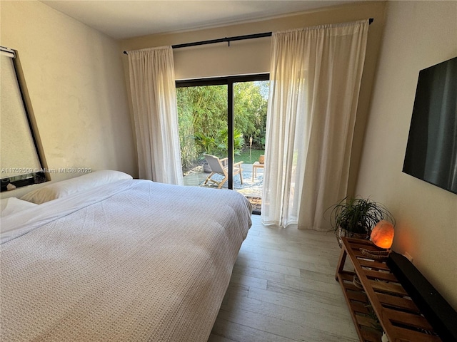 bedroom featuring hardwood / wood-style flooring and access to exterior