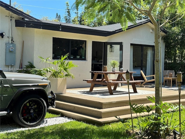 back of property featuring stucco siding