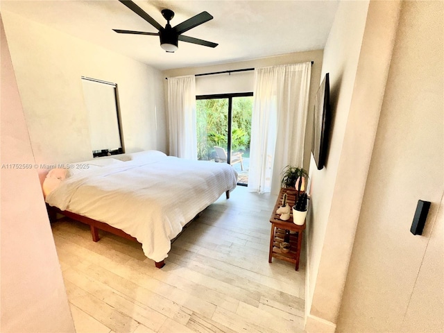 bedroom featuring a ceiling fan, access to outside, and hardwood / wood-style flooring