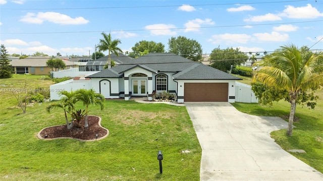 view of front of property featuring a garage, fence, concrete driveway, french doors, and a front yard