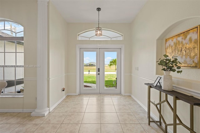 entryway featuring baseboards, french doors, tile patterned flooring, and ornate columns