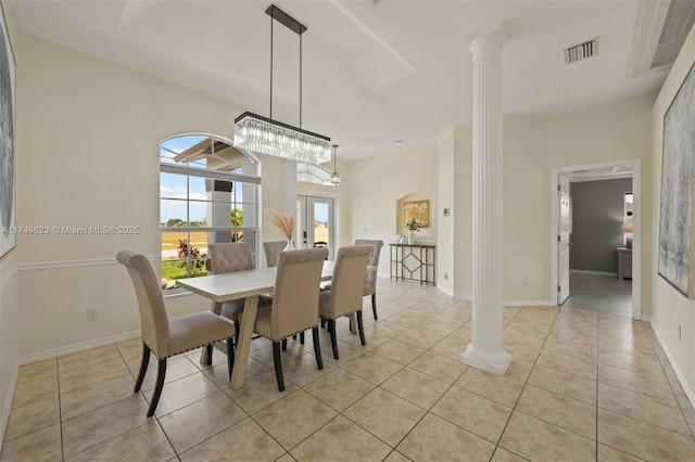 dining space with decorative columns, visible vents, baseboards, and light tile patterned flooring