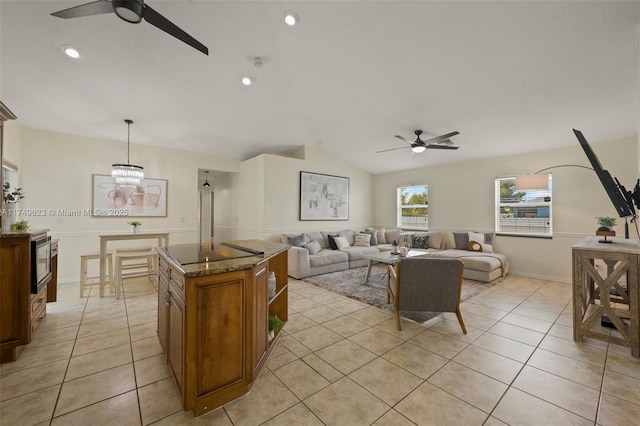 living area featuring light tile patterned floors, ceiling fan with notable chandelier, lofted ceiling, and recessed lighting