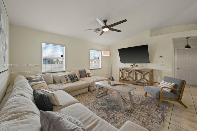 living area with lofted ceiling, light tile patterned floors, and ceiling fan