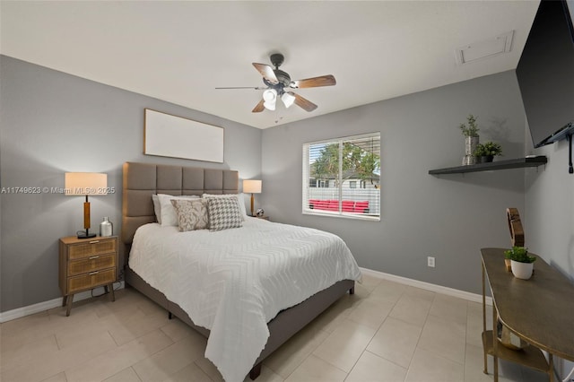 bedroom featuring a ceiling fan, baseboards, and light tile patterned floors