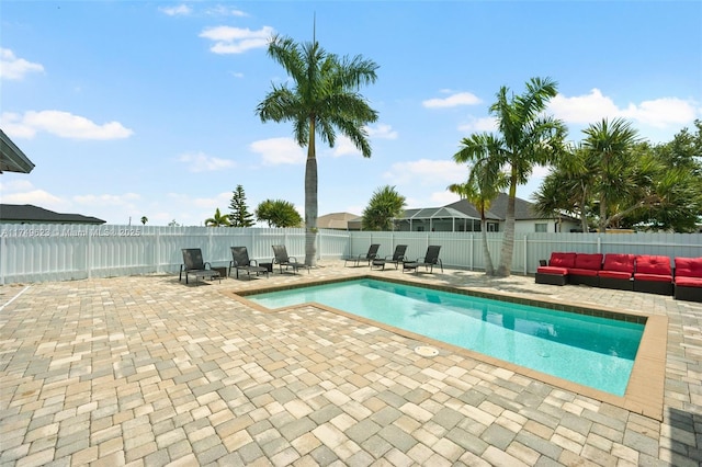 view of swimming pool featuring outdoor lounge area, a patio area, a fenced backyard, and a fenced in pool