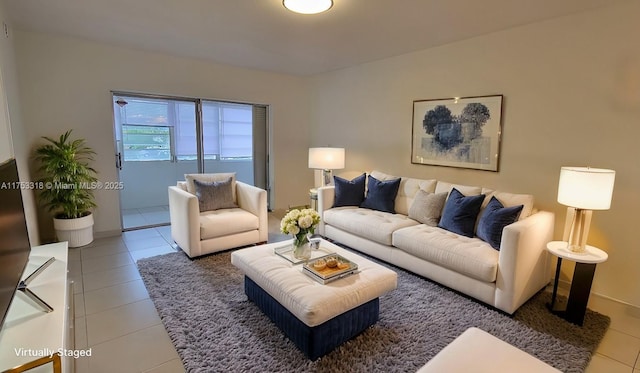 tiled living area featuring baseboards