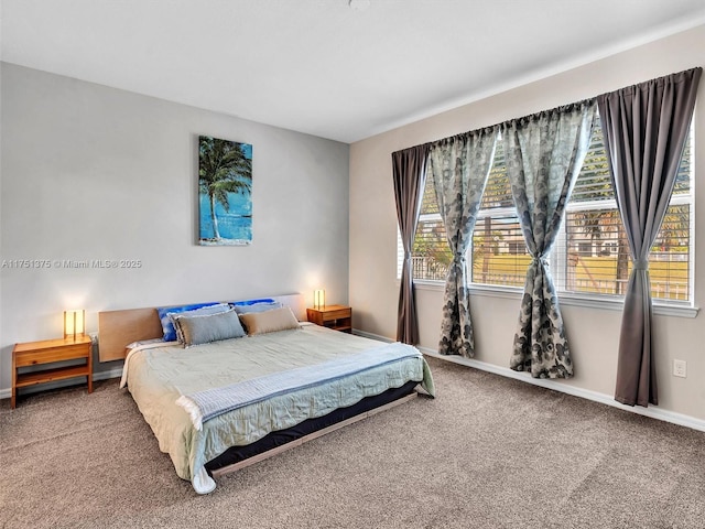 carpeted bedroom featuring baseboards