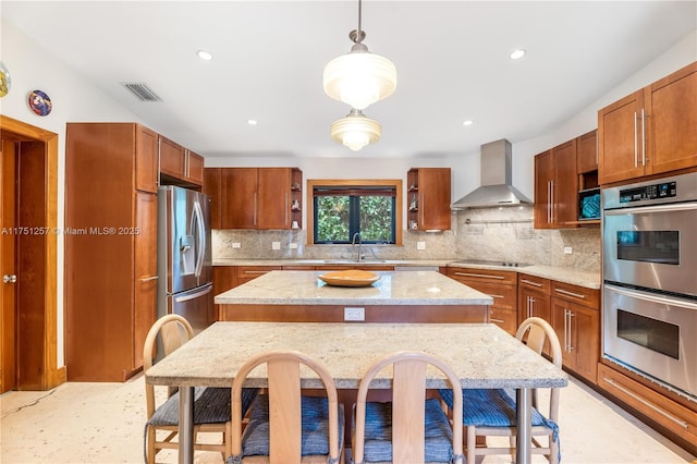 kitchen featuring open shelves, visible vents, appliances with stainless steel finishes, a sink, and wall chimney exhaust hood