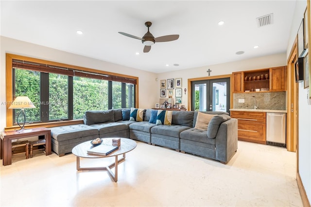 living room with recessed lighting, visible vents, indoor wet bar, and french doors