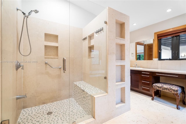 bathroom featuring recessed lighting, a shower stall, and vanity