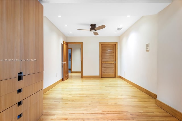 unfurnished room featuring recessed lighting, light wood-type flooring, visible vents, and baseboards