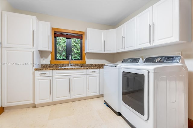 clothes washing area featuring cabinet space, a sink, and separate washer and dryer