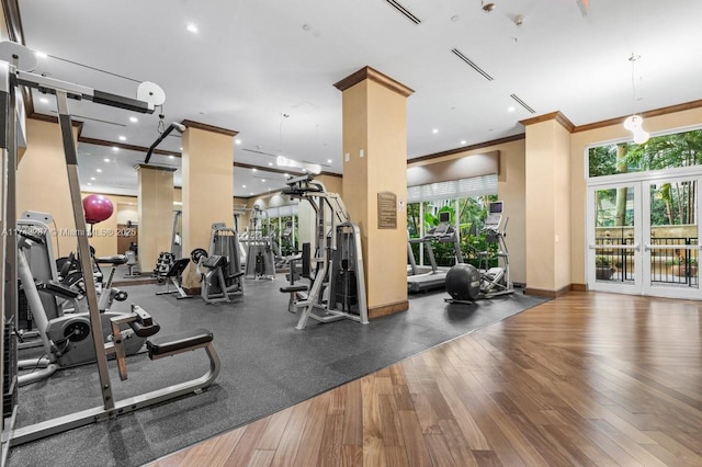 gym featuring recessed lighting, wood finished floors, baseboards, french doors, and crown molding