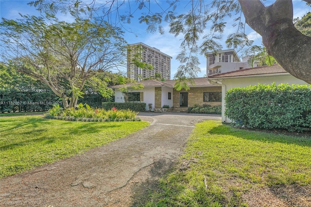 1915 S Miami Ave, Miami, FL 33129 - view of front facade with stucco siding, a front lawn, and driveway