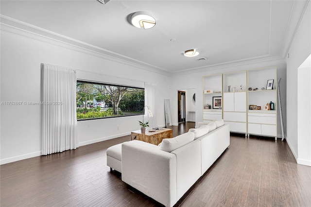 living room featuring baseboards, visible vents, dark wood-style flooring, and crown molding