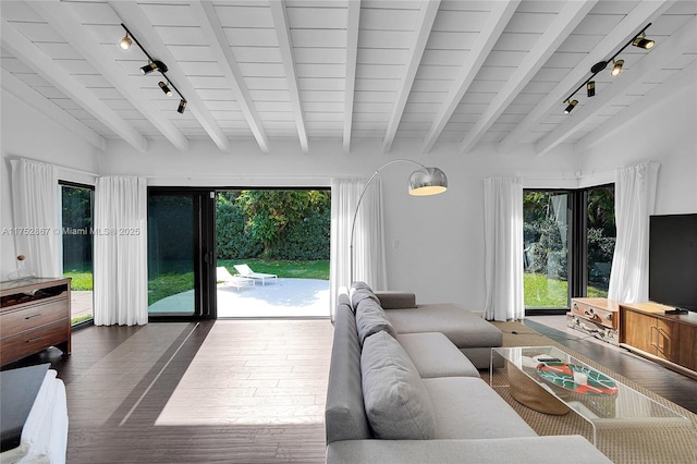 living area featuring beam ceiling, track lighting, and wood finished floors