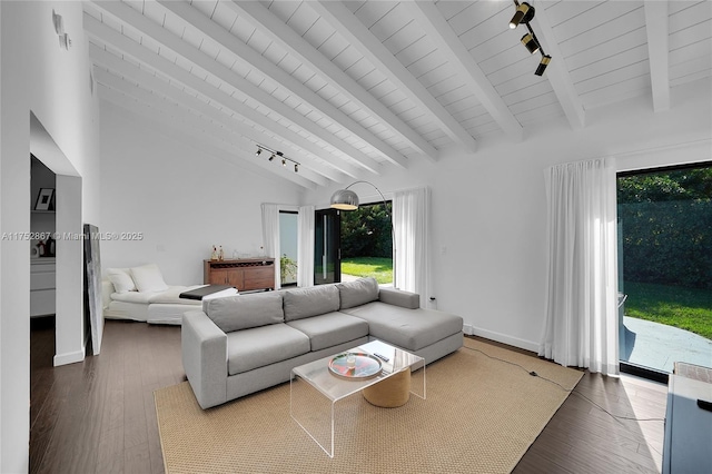 living area with vaulted ceiling with beams, track lighting, wood finished floors, wooden ceiling, and baseboards