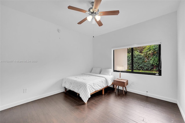 bedroom with wood finished floors, a ceiling fan, and baseboards