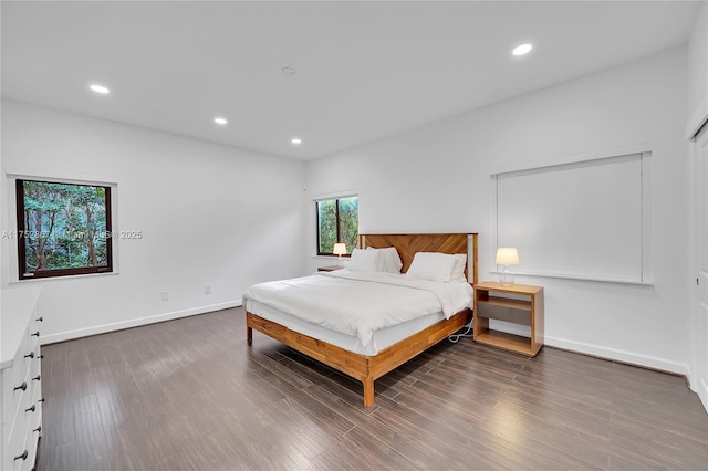 bedroom featuring baseboards, wood finished floors, and recessed lighting