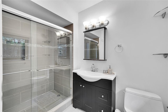 full bath featuring vanity, a shower stall, and toilet