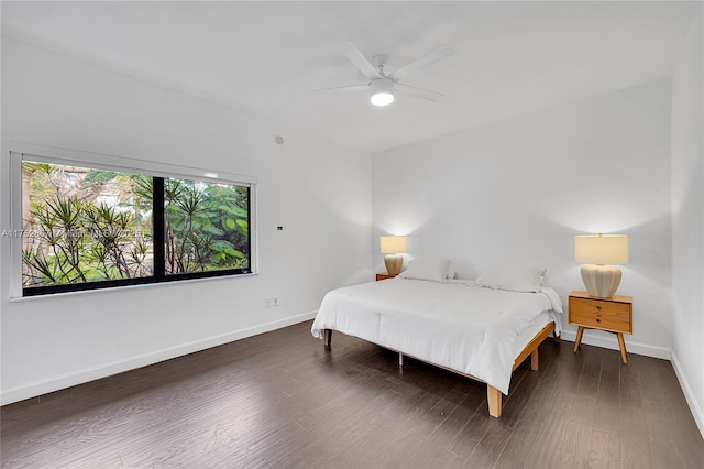 bedroom with a ceiling fan, baseboards, and wood finished floors