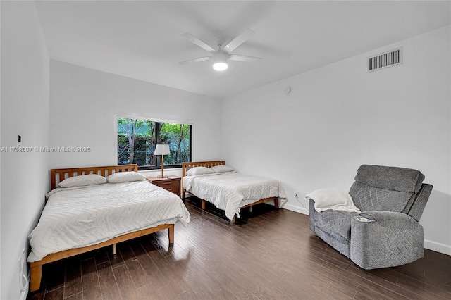 bedroom featuring baseboards, visible vents, ceiling fan, and wood finished floors