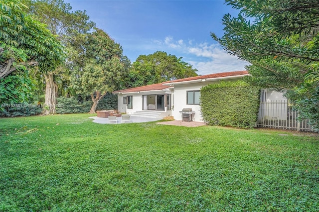 back of property with entry steps, fence, a yard, a patio area, and stucco siding