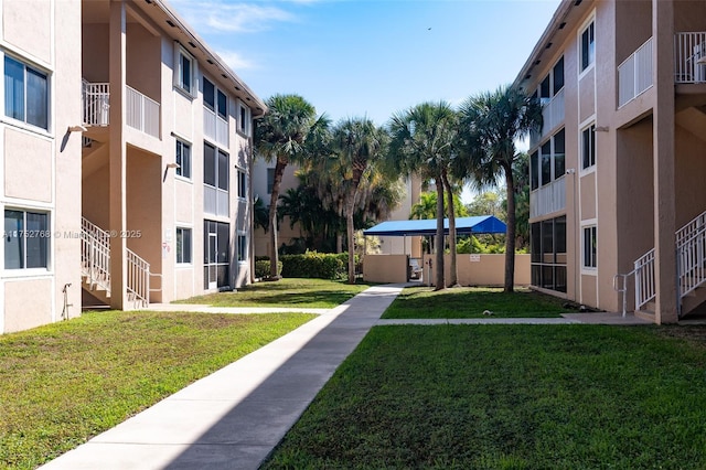 view of property's community featuring a residential view and a lawn