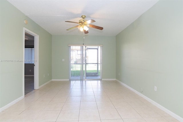 unfurnished room featuring light tile patterned floors, a ceiling fan, and baseboards