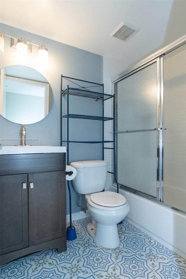 full bath featuring bath / shower combo with glass door, visible vents, toilet, vanity, and tile patterned floors