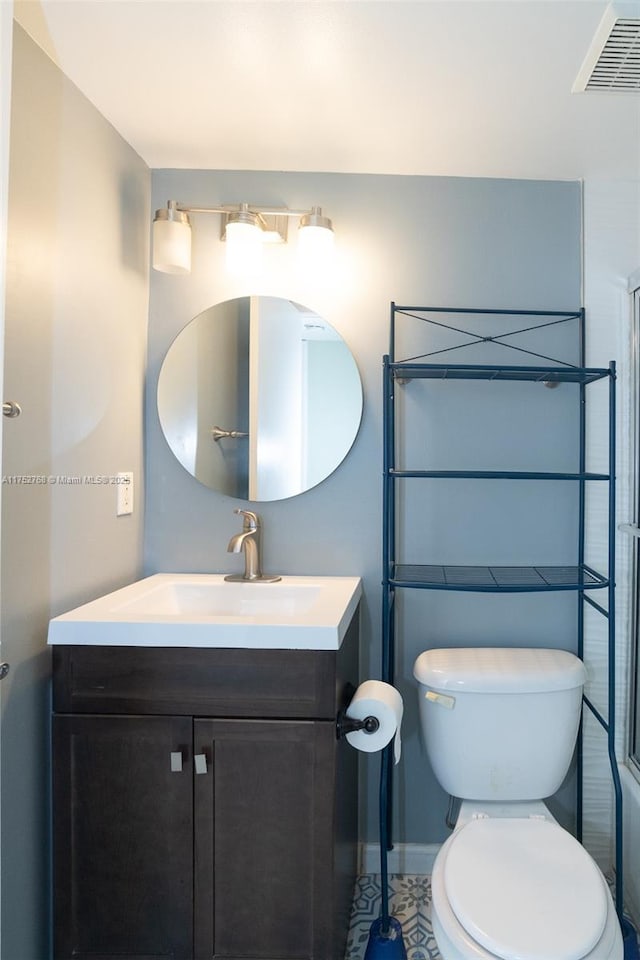 bathroom with toilet, baseboards, visible vents, and vanity