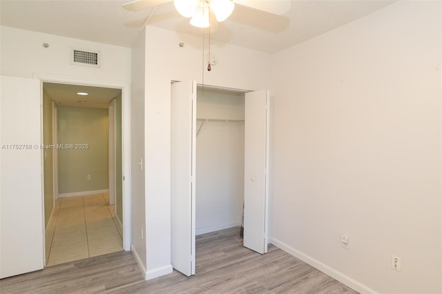 unfurnished bedroom with a ceiling fan, visible vents, baseboards, a closet, and light wood-type flooring