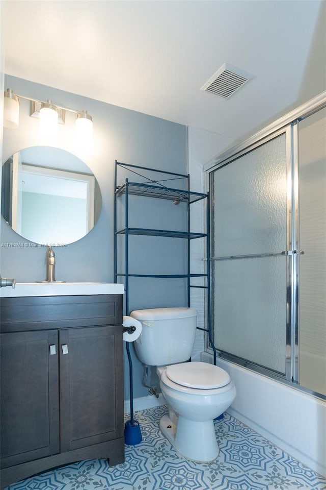 full bath with toilet, vanity, visible vents, combined bath / shower with glass door, and tile patterned floors