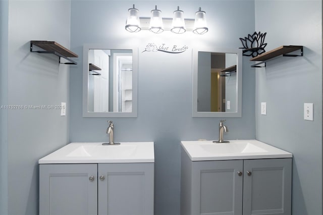 bathroom featuring two vanities and a sink