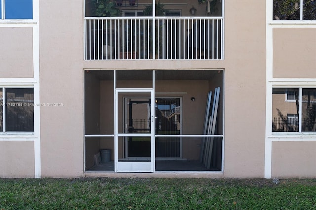 doorway to property with stucco siding