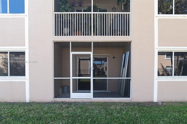 property entrance with stucco siding