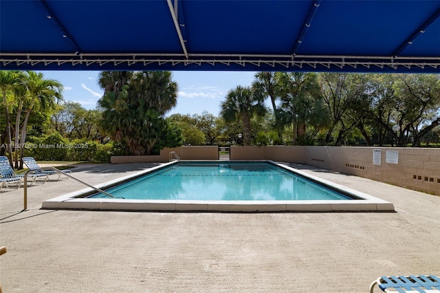 pool featuring a patio and fence