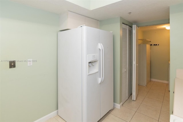 interior space featuring baseboards, a closet, and tile patterned floors