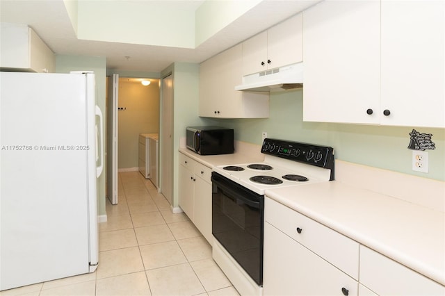 kitchen with washing machine and dryer, under cabinet range hood, range with electric stovetop, white cabinets, and freestanding refrigerator